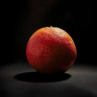 An orange on a black background photo