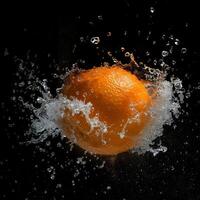 An orange being splashed with water photo