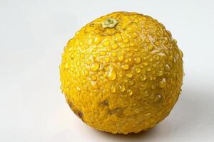 A yellow fruit with water droplets on it photo