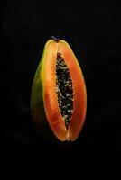 A papaya on a black background photo