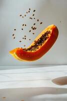A papaya is being cut open by a knife photo