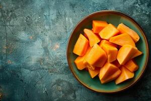 A plate of sliced mangoes on a table photo