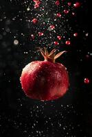 A pomegranate is being sprayed with water photo