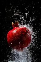 A pomegranate is being splashed with water photo