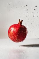 A pomegranate is being thrown into the air photo