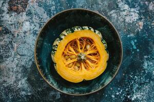 A squash with seeds on top of a blue background photo