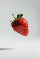 A single strawberry is flying in the air photo