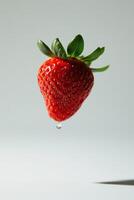 A strawberry is falling from the sky photo