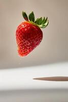 A strawberry is being thrown into the air photo