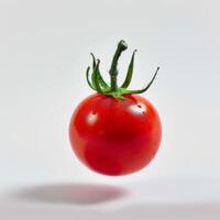 A single tomato is floating in the air photo