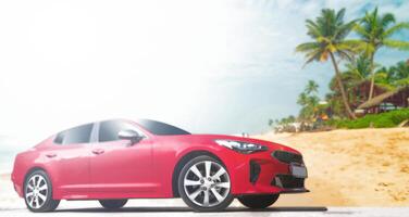Red car on a background of palm trees. Stylish, modern, bright image of the car for design solutions. photo