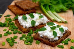 Whole grain bread with feta cheese and herbs. photo