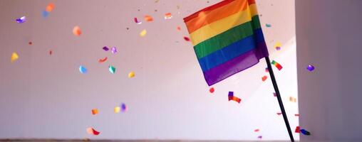 A rainbow flag with confetti thrown around it photo