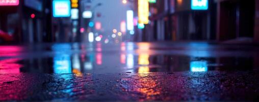 An image of a wet street at night with neon lights photo