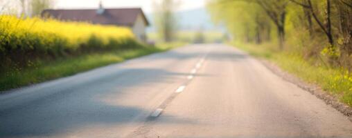 A blurry image of an empty road with trees in the background photo