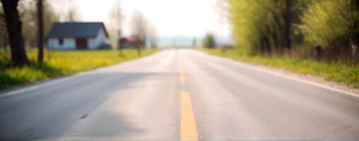 A blurry image of an empty road with trees in the background photo