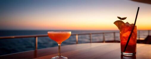 Two cocktails on a wooden table at sunset photo