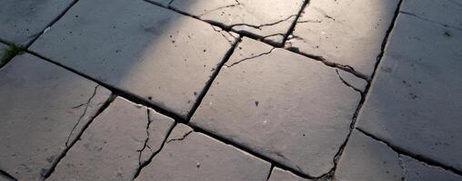 A stone floor with cracks in it photo