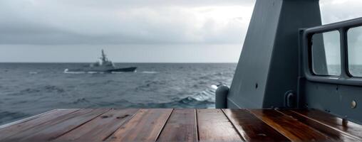 A military ship is seen from the deck of the boat photo