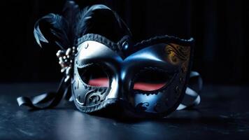 Black and silver masquerade mask on a black background photo