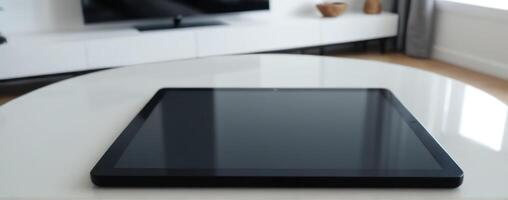 Tablet pc on a white table in the living room photo