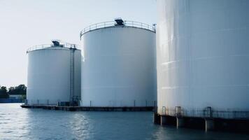A group of large white tanks in the water photo