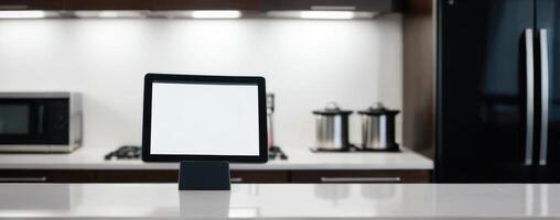 An ipad tablet sitting on a counter in the kitchen photo
