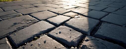 An image of a cobblestone road with the sun shining on it photo