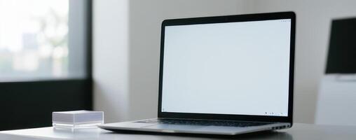A laptop computer with an empty screen on top of it photo