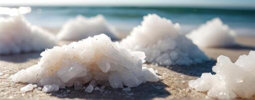 A group of white crystals sitting on the sand photo