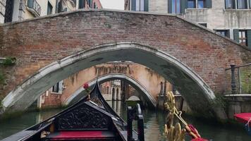 A ride in a gondola under the small bridges in Venice video
