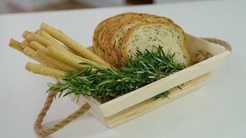 Homemade cheese bread sticks and fresh toaster bread in a light wooden basket video