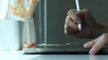 Hand using digital stylus writing on tablet. Concept of digital signature Signing documents electronically via tablet or taking notes electronic video