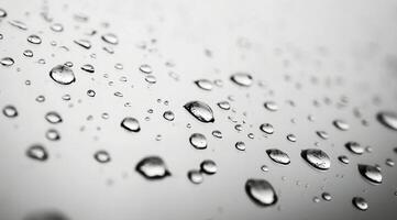 Close-up of raindrops on a smooth surface highlighting nature's delicate beauty during a rainy day photo