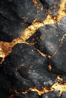 Golden veins of mineral deposits across a dark stone surface under natural light photo