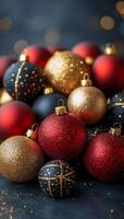 Vibrant assortment of festive Christmas ornaments in red, gold, and black on a dark background photo