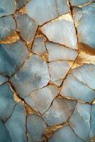 Golden veins of mineral deposits across a dark stone surface under natural light photo