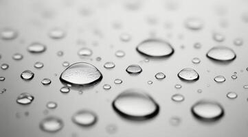 Close-up of raindrops on a smooth surface highlighting nature's delicate beauty during a rainy day photo
