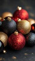 Vibrant assortment of festive Christmas ornaments in red, gold, and black on a dark background photo