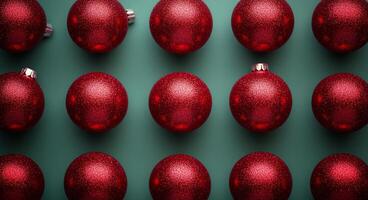 Bright red Christmas ornaments arranged on a green surface for festive holiday decoration photo