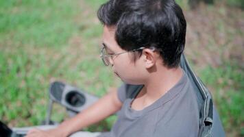 Programmer looking for inspiration to make a decision, stress from work, working online, worrying, working in the park, serious man search for inspiration make decision feel lack of ideas. video