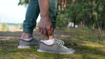 Man with mosquitoes bites itching leg, applying balm on swell skin, suffering from allergic reaction video