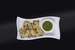 Fried Chicken and green chutney isolated view photo