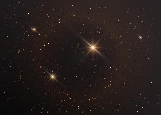 Stars in the night sky on a black background. Magical Christmas dust with glowing stars and light effects