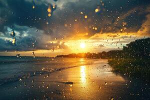 Golden sunset over the ocean with raindrops glistening on the shore during twilight hours photo