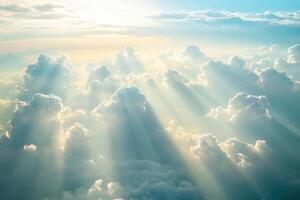Sunlight streaming through textured clouds in a serene sky during the early morning hours photo