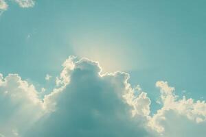 Sunlight shining through fluffy clouds in a bright sky during midday photo