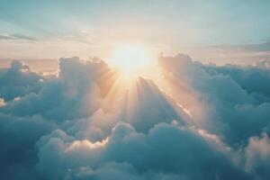 Majestic sunrise over clouds with rays of sunlight breaking through in a tranquil morning sky photo