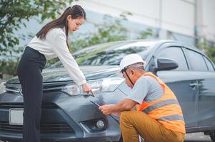male insurance officer came to help inspect a customer's car that had an accident. Concept for vehicle crash, insurance claim. photo