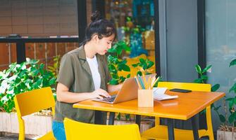 Freelance worker working on documents with graphs. and information about finances on laptops in cafes photo